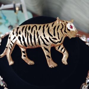 1980's vintage goldtone tiger brooch with ruby eye